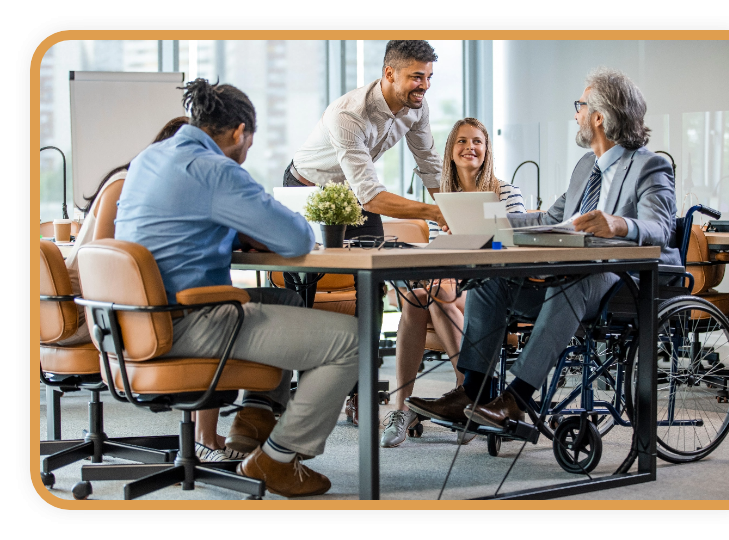 A diverse group of colleagues meet around a conference table