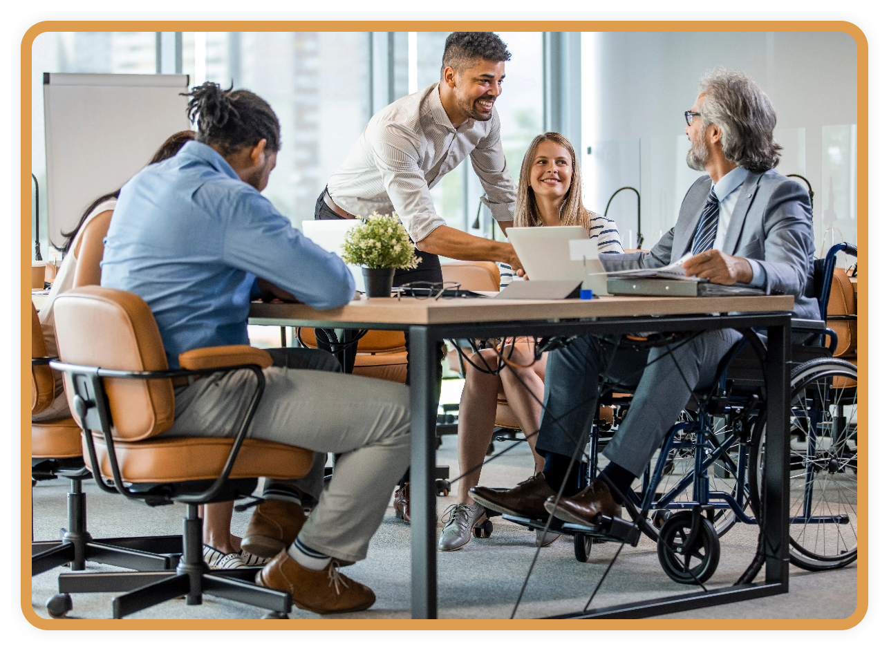 A diverse group of colleagues meet around a conference table