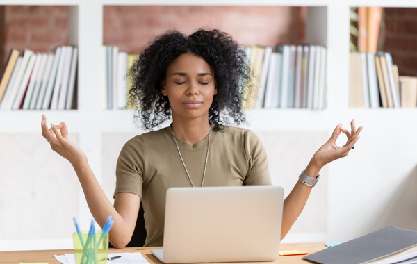 CHRO Benefits Specialist finding calm at her desk during Open Enrollment
